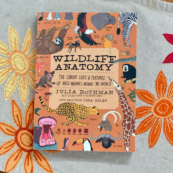 Book titled 'Wildlife Anatomy' on a floral-patterned surface