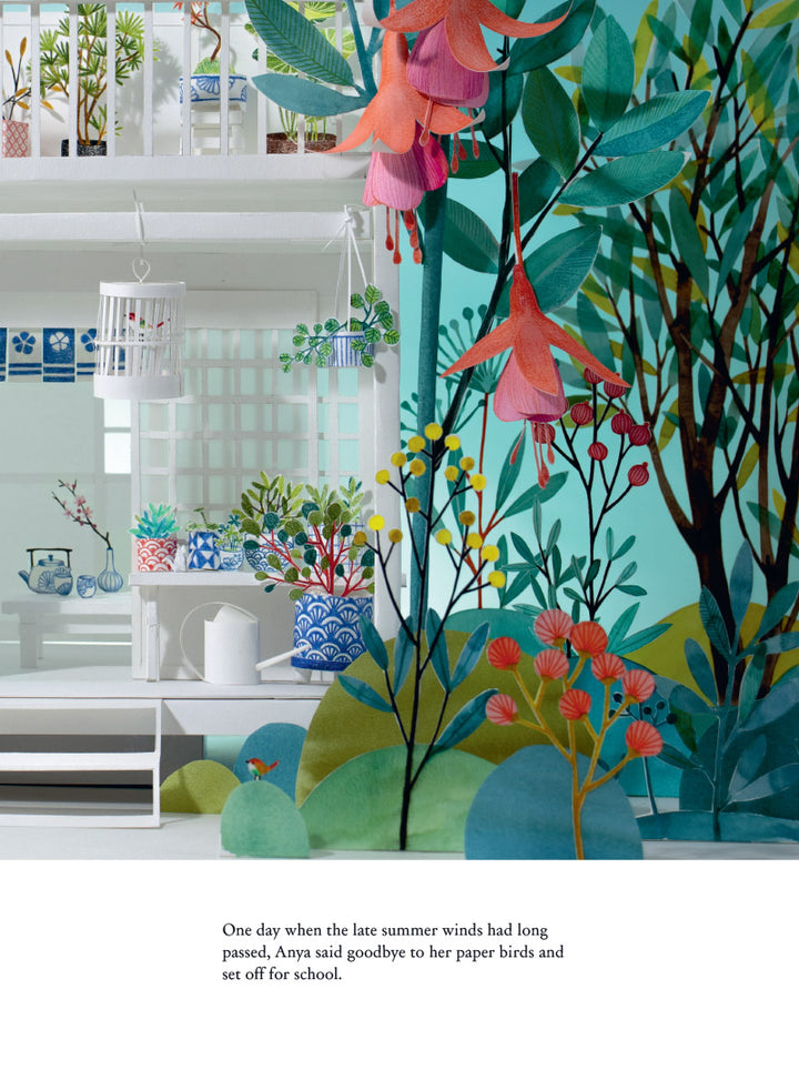 Room with floral wallpaper and plants, featuring a kitchen area.