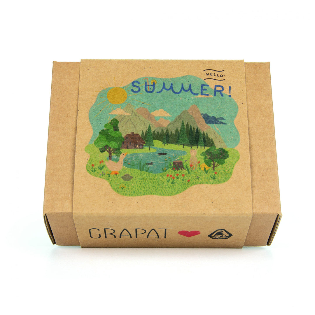 Ostheimer x Grapat collaboration. 
 Cardboard box with a summer-themed illustration and 'Grapat' branding on a white background