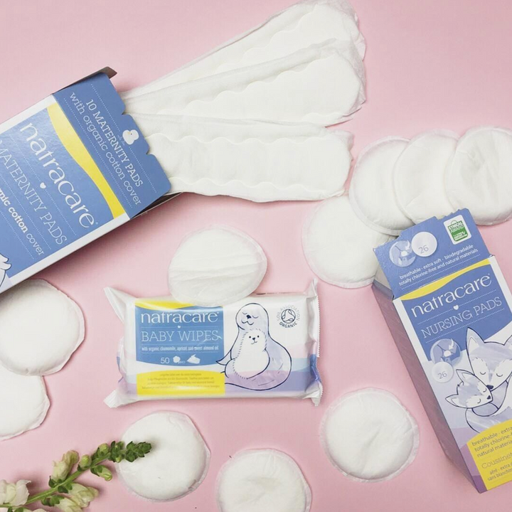 Natracare organic maternity pads, nursing pads, and baby wipes, pictured together.