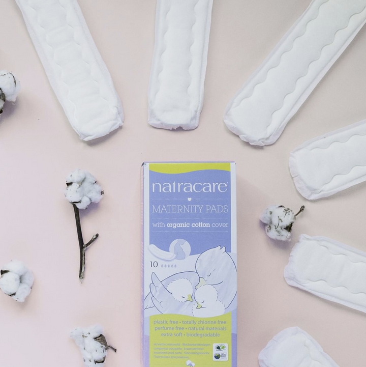 Box of Natracare maternity pads, pictured with cotton buds and maternity pads out of the box.