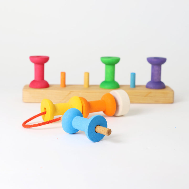 Grimm's coloured wooden bobbins threading game