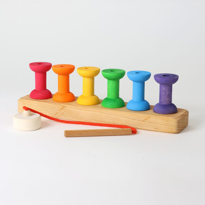 Grimm's coloured wooden bobbins threading game