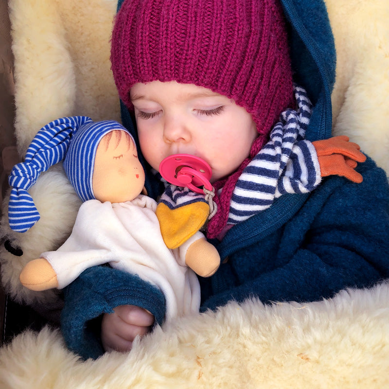 sleeping grasping doll, blue striped cap