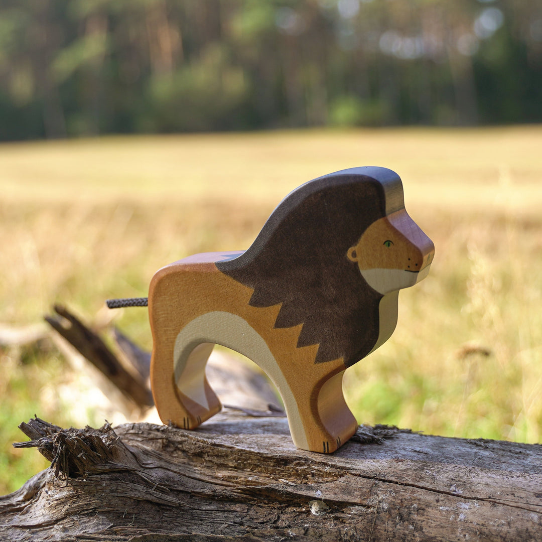 Holztiger wooden lion toy on a log with a natural background