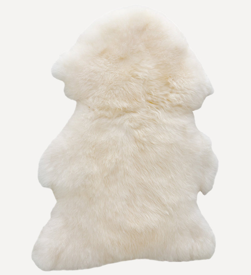 White sheepskin rug on a white background
