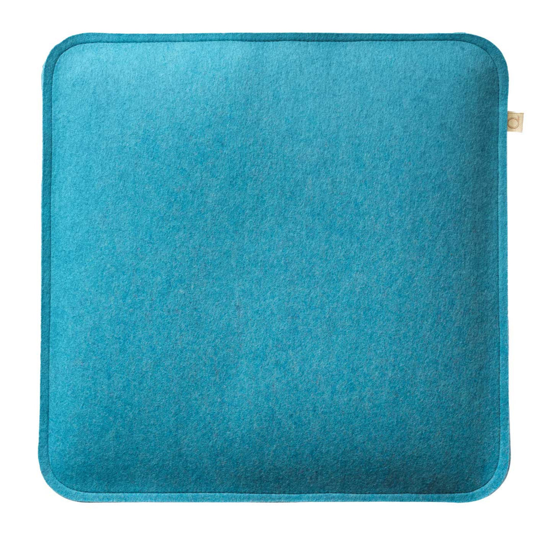 Blue wool felted cushion on a white background