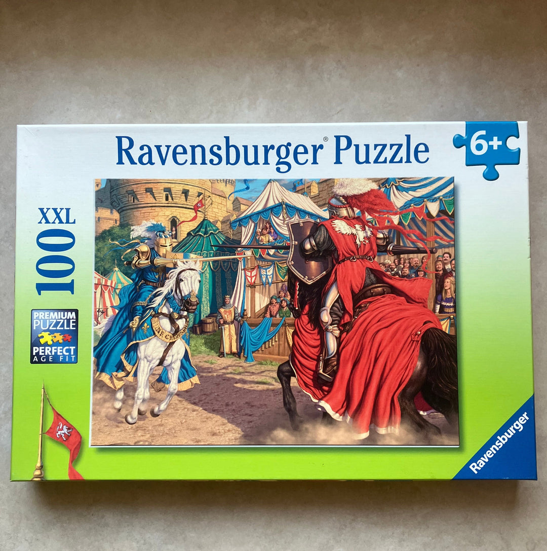 Ravensburger puzzle box with colorful illustration on a gray surface