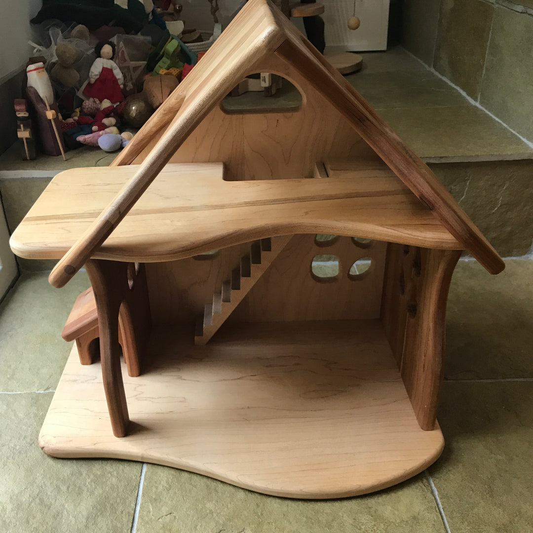Wooden dollhouse on a tiled floor