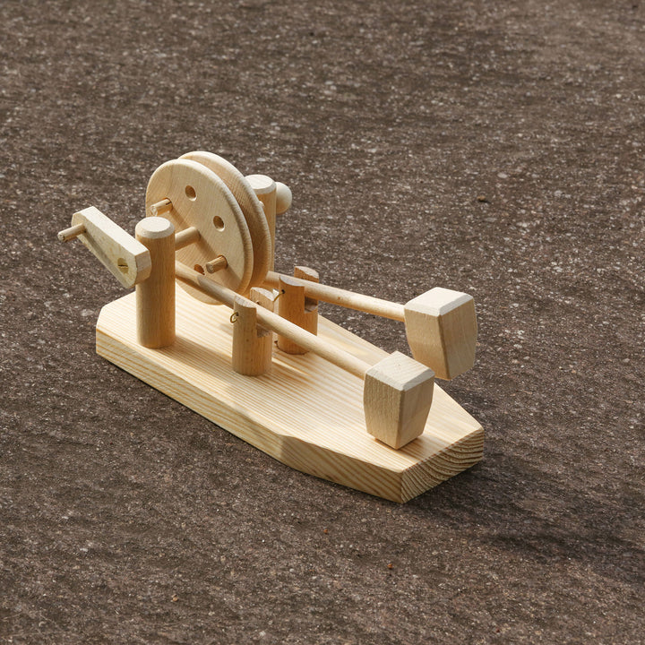 Wooden Toy Science Experiment Hammer Mill Physics kit on brown fabric background