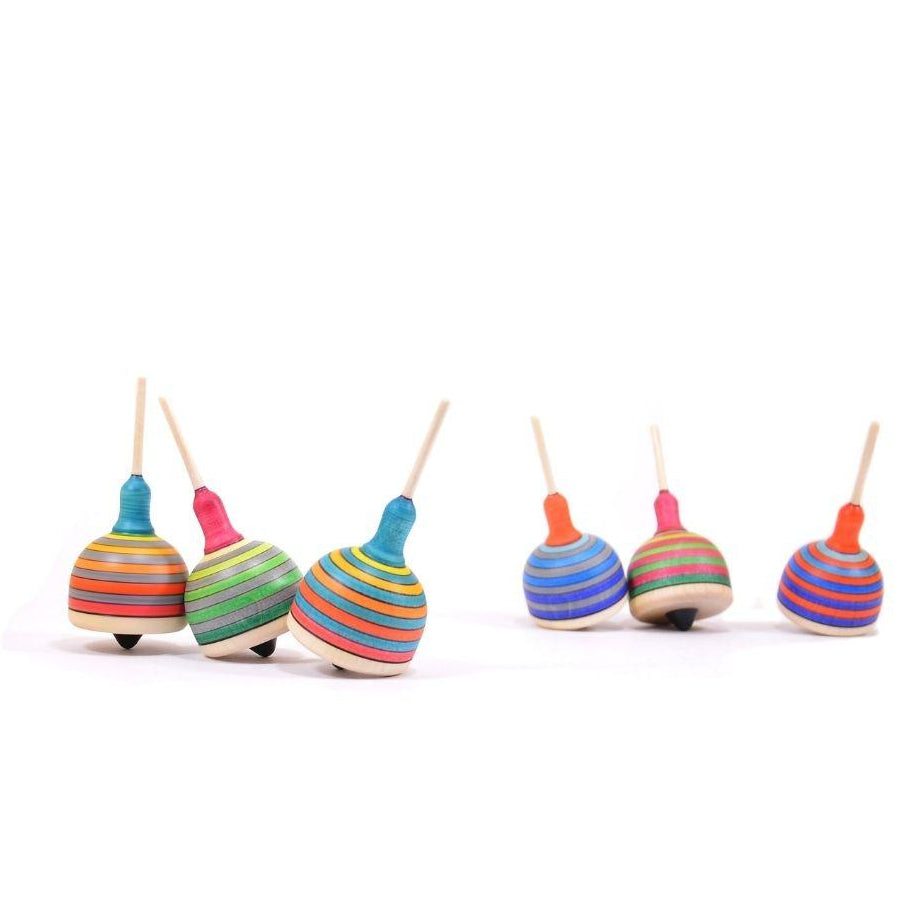 Set of colorful wooden spinning tops on a white background