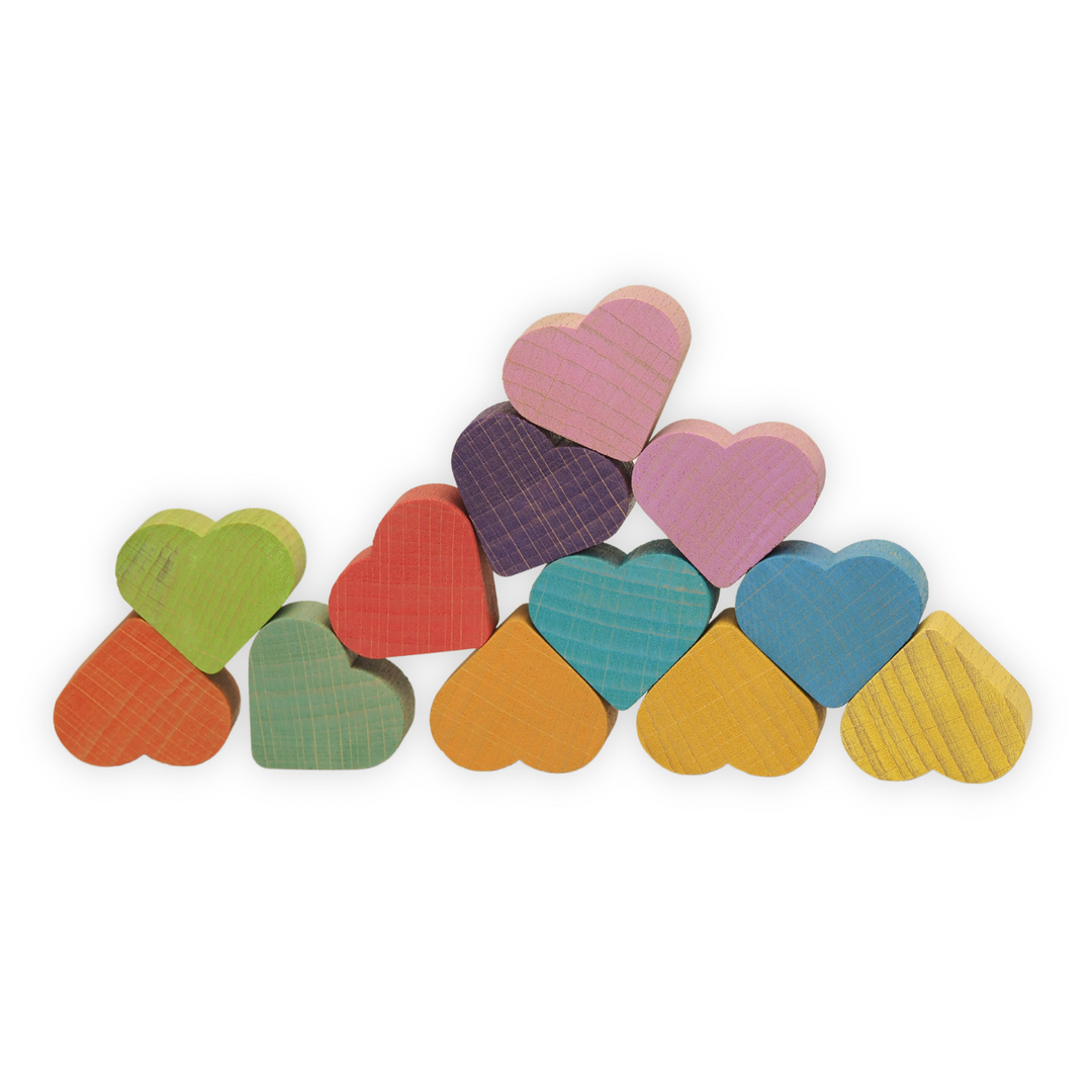 Colorful heart-shaped wooden blocks arranged in a stack on a white background