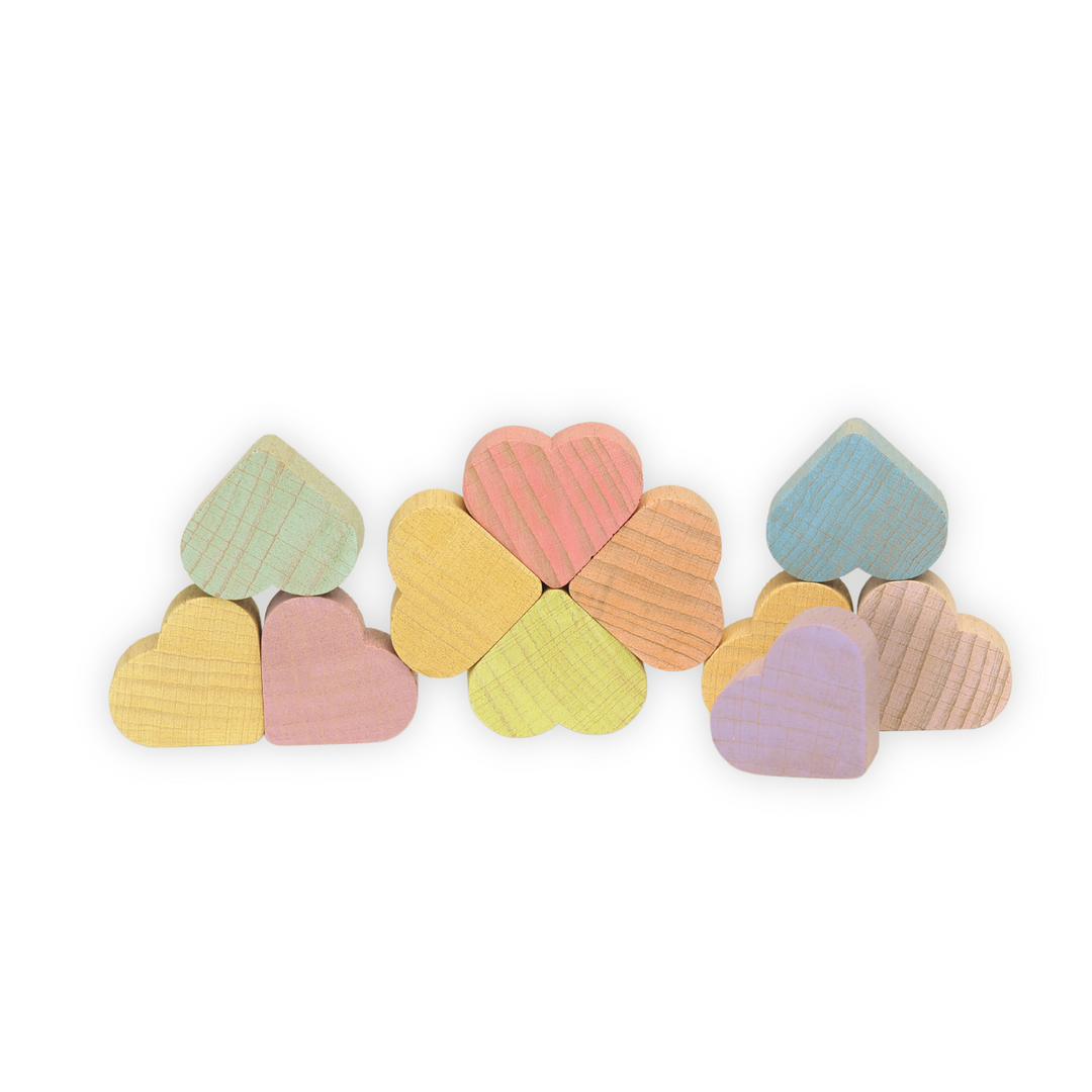 Set of colourful Ocamora brand pastel wooden hearts on a white background