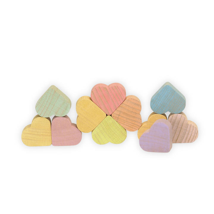 Set of colourful Ocamora brand pastel wooden hearts on a white background