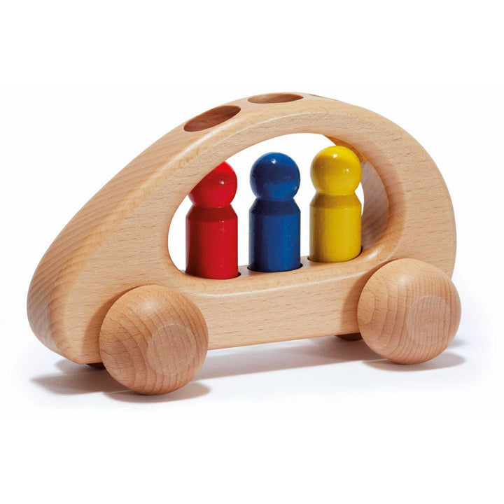 White wooden toy car with 3 removable peg people in red, blue, and yellow on a white background