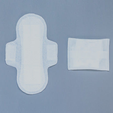 Two white Natracare sanitary pads and a small square pad on a grey background with cotton branches.