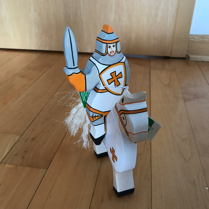Holztiger white knight riding atop tournament horse