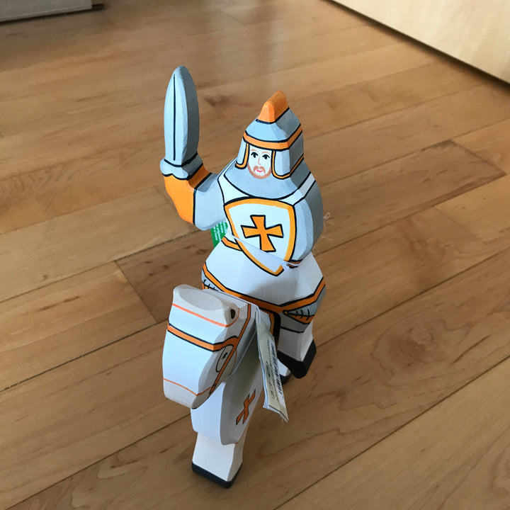 Holztiger white knight riding atop tournament horse